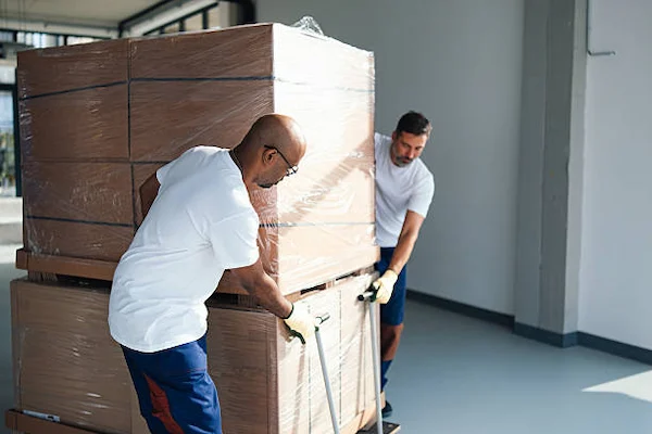 Professional movers loading furniture into commercial truck